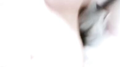 Girl sticks out her tongue on the bed