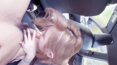 A beautiful girl gives a blowjob in the car