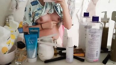 Sister grabs breasts in front of mirror while wearing underwear