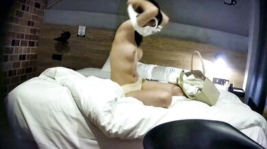 College student couple takes selfies on hotel date